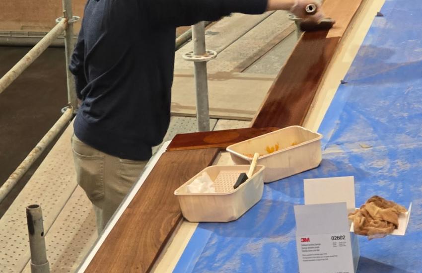Capt. Adam Jay begins refinishing the toerail